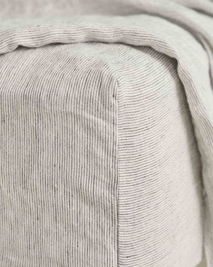 Linen fitted sheet with pinstripe pattern from CULTIVER, showcasing a close-up of the bed linen fabric and fitted edges.