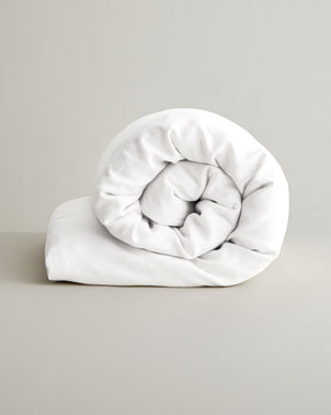 White linen duvet cover by CULTIVER, showcasing soft fabric and simple, elegant design on a bed.