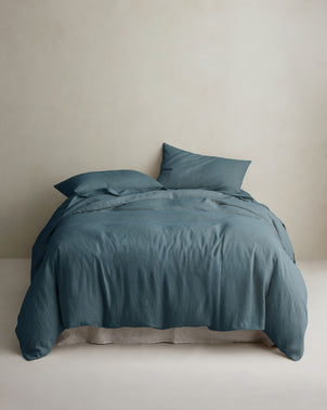 CULTIVER Linen duvet cover in Bluestone styled on a bed with matching pillowcases, showcasing soft, textured bed linen.
