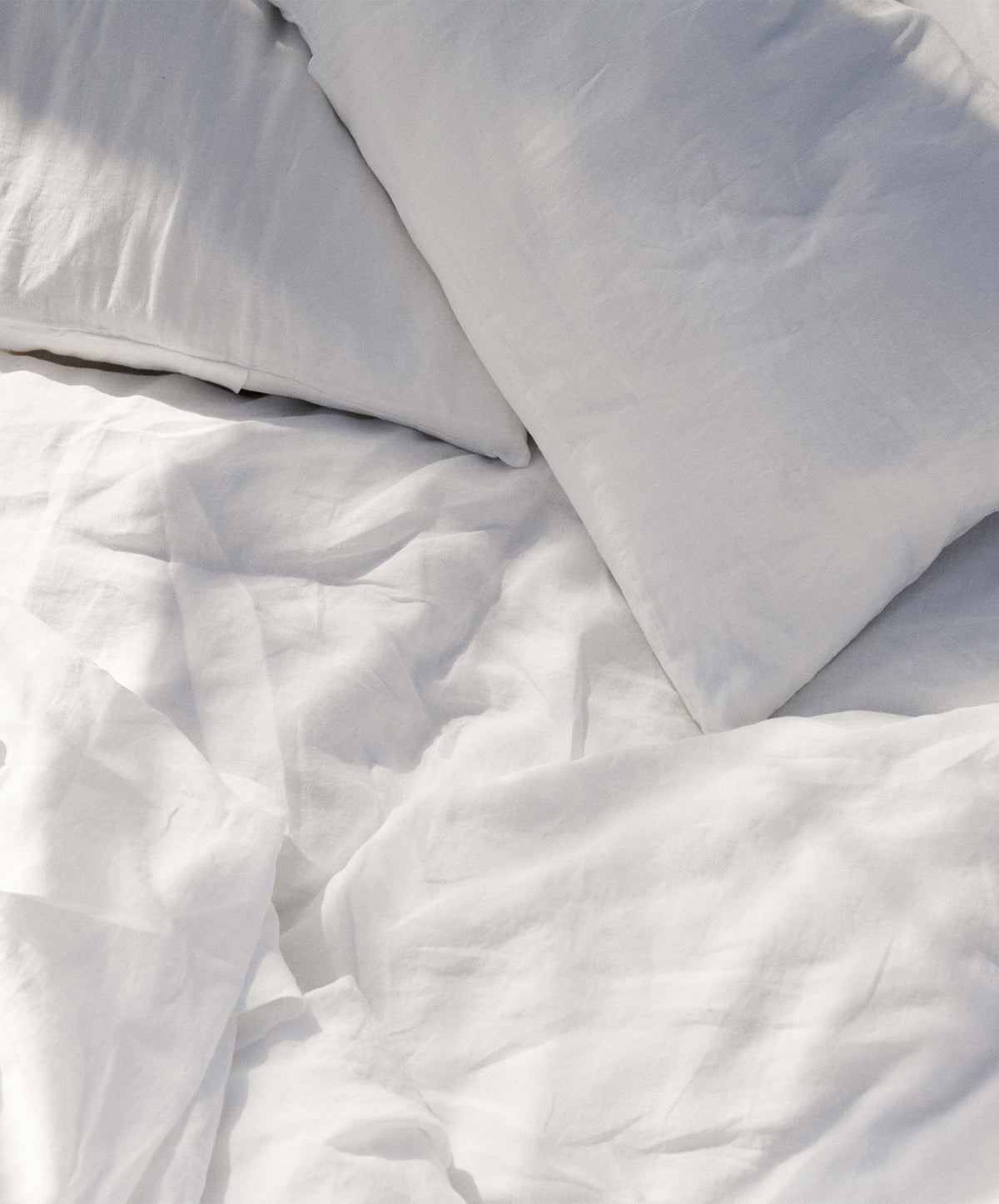 Set of 2 white linen Euro pillowcases by CULTIVER, showcasing smooth, crisp fabric and clean, minimal design for bedroom decor.