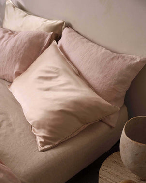 Blush silk linen flip pillowcase by CULTIVER, showing smooth, luxurious fabric with subtle sheen and elegant stitching.