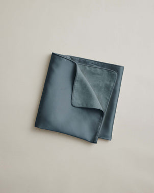 A neatly folded, double-layered Silk Linen Flip Pillowcase - Bluestone placed on a plain, light-colored surface.