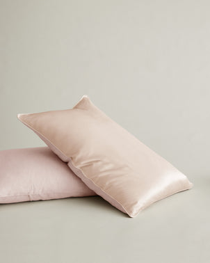 Blush silk and linen flip pillowcase from CULTIVER, showing soft, smooth fabric with a luxurious bedroom setting.