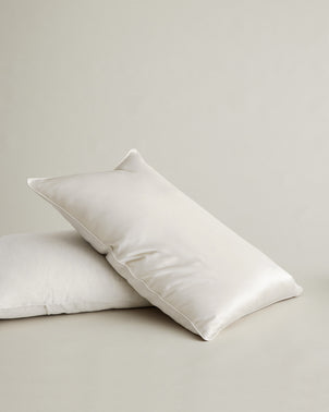 Ivory silk linen flip pillowcase by CULTIVER, showcasing smooth fabric and elegant design for a luxurious bedroom look.