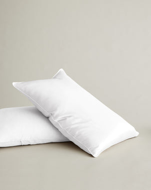 White silk linen flip pillowcase by CULTIVER, showing smooth, luxurious fabric on a cozy bed linen bed pillow.