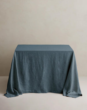 Linen Bluestone tablecloth by CULTIVER styled on a wooden dining table, showcasing a smooth, elegant table linen for home decor.