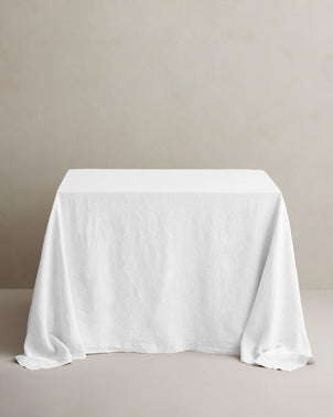 White linen tablecloth by CULTIVER styled on a table, showcasing a smooth, elegant fabric perfect for dining or special occasions.