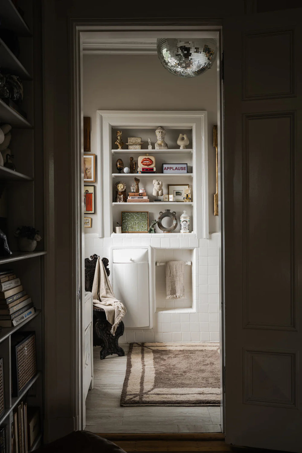 Bathroom with a freestanding bathtub, towel, and decorative elements.
